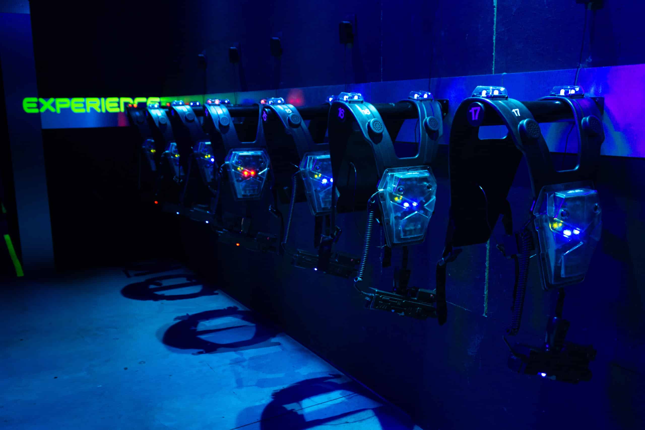Lasertag vests hanging in a dark room.